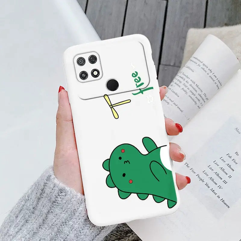 a woman holding a phone case with a green fish on it