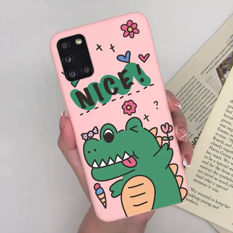 a hand holding a pink phone case with a cartoon character on it