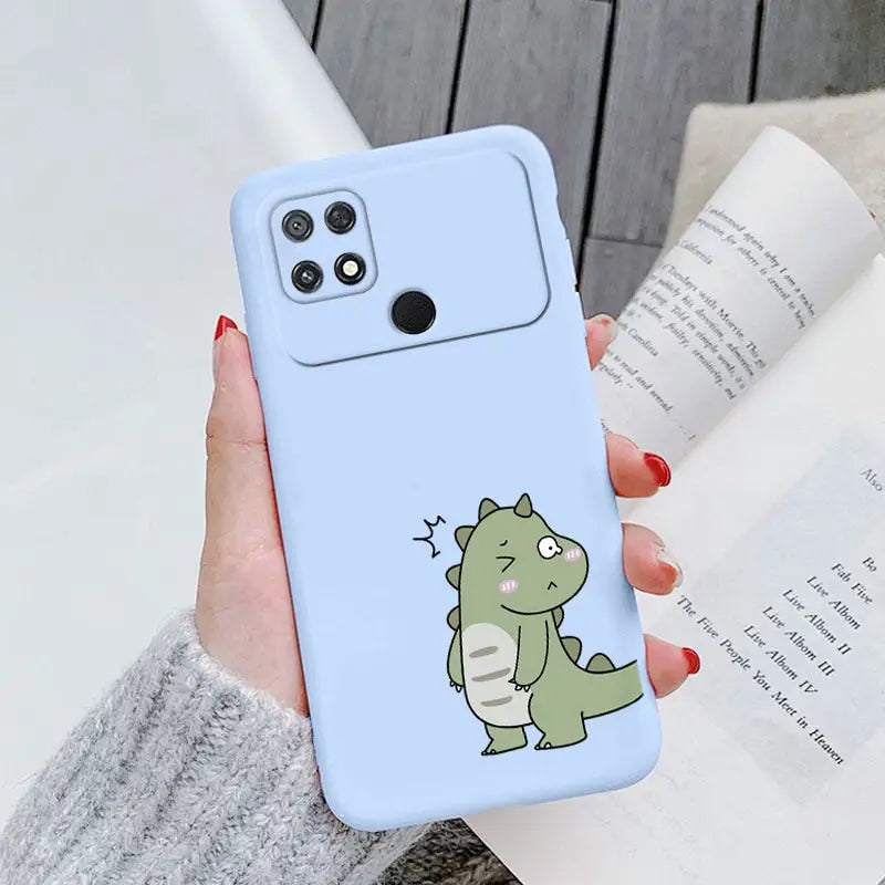 a woman holding a phone case with a cartoon dinosaur