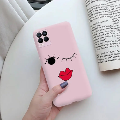 a woman holding a pink phone case with a cartoon face