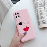 a woman holding a pink phone case with a cartoon face