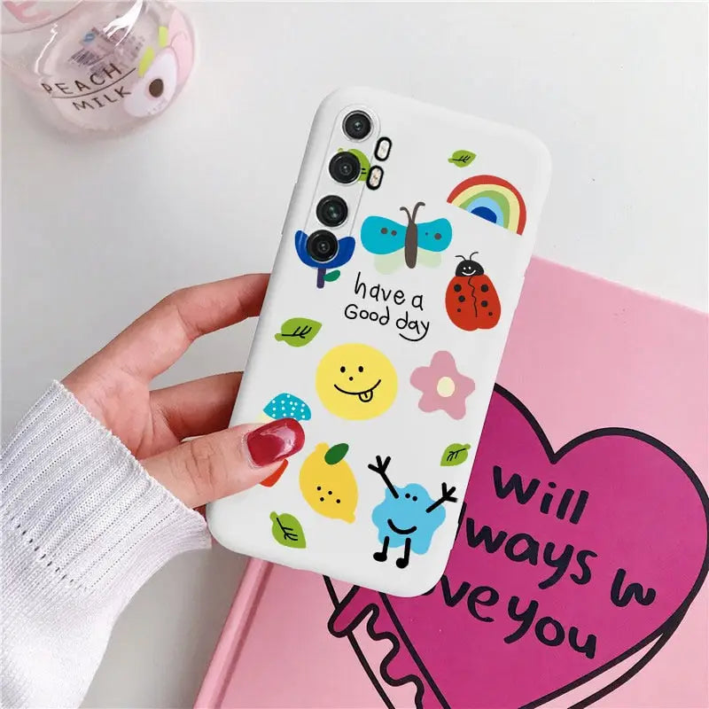 a person holding a phone case with a heart and fruit design