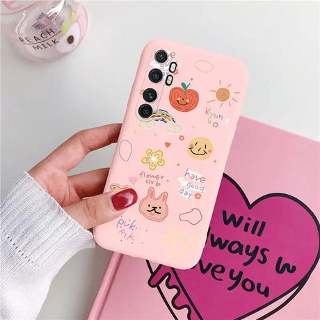 a woman holding a pink phone case with a heart and a sticker