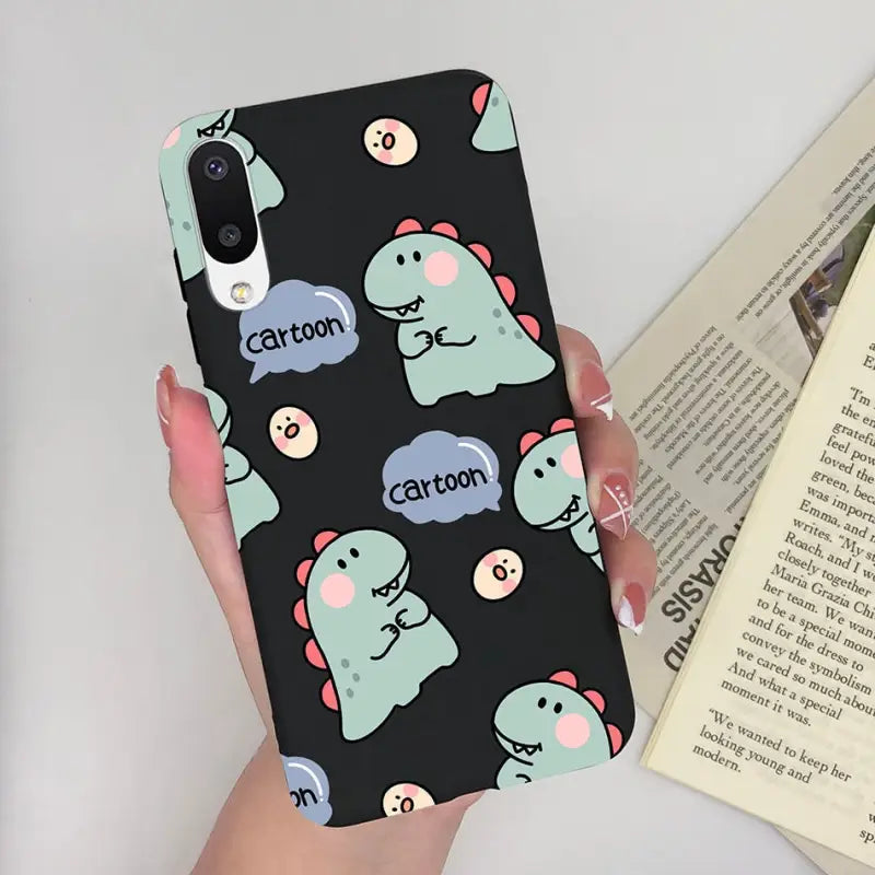 a woman holding a phone case with a pattern of whales