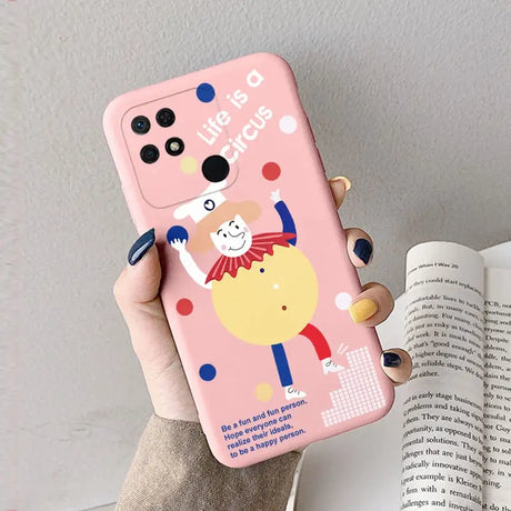 a woman holding a pink phone case with a cartoon character on it