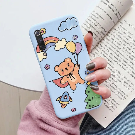 a woman holding a phone case with a cartoon character on it