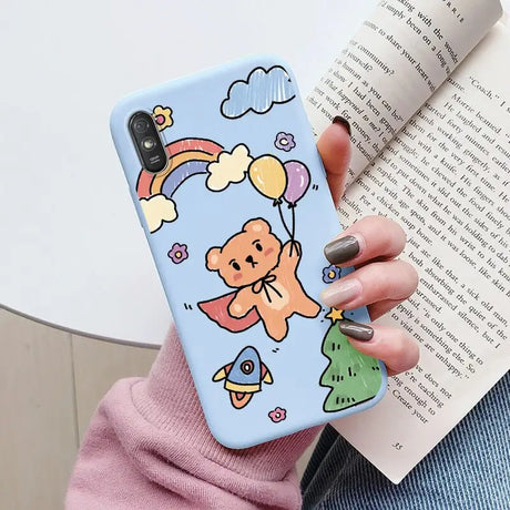 a woman holding a phone case with a cartoon character on it