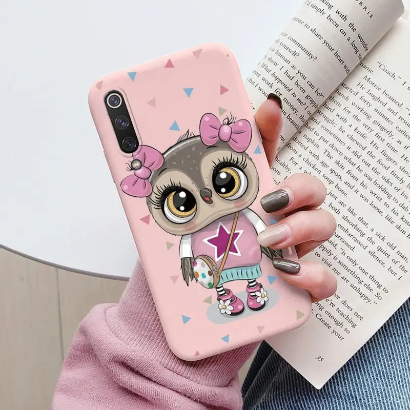 a girl with a pink bow and a pink heart phone case
