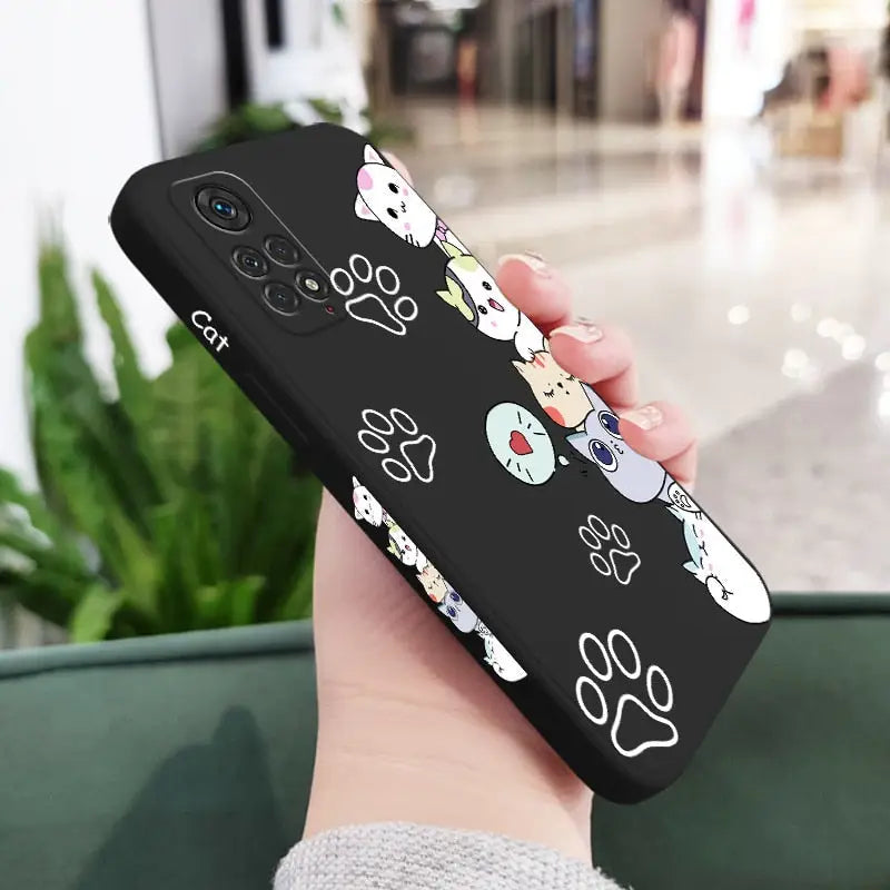 a hand holding a phone case with a cartoon character design