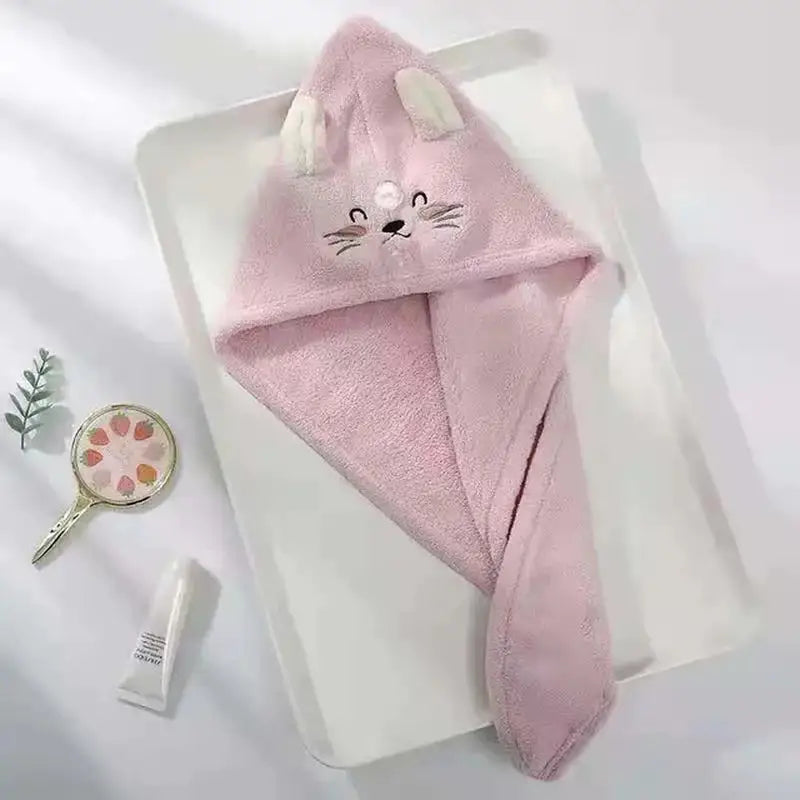 a pink towel with a cat face on it