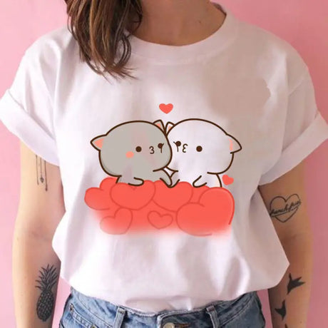 a woman wearing a white shirt with a cartoon cat and dog on it