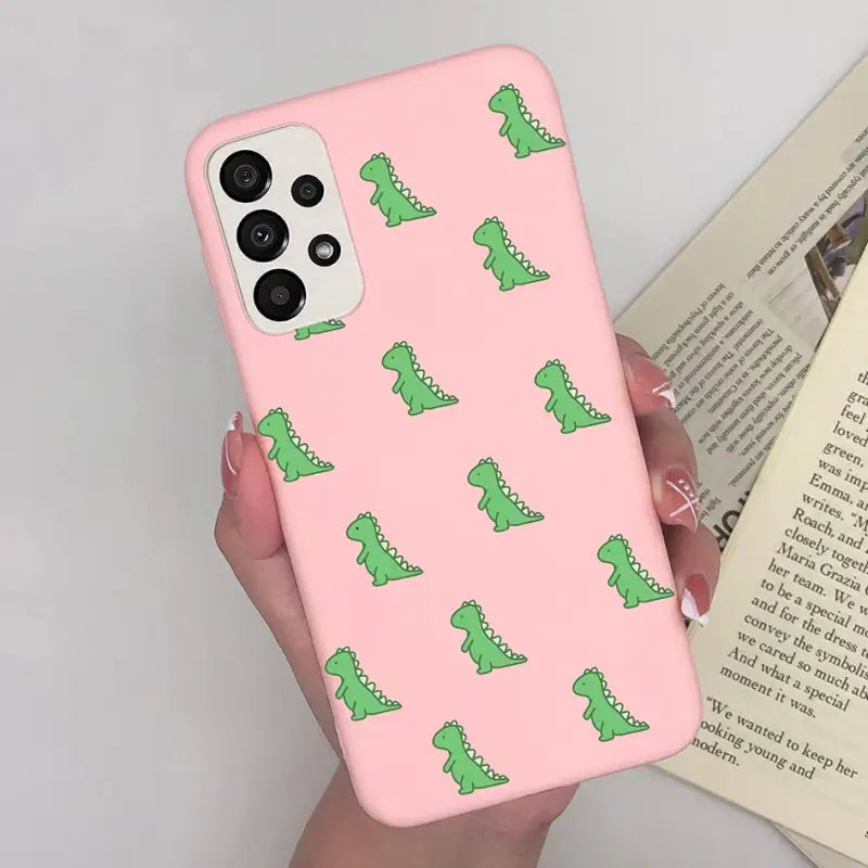 a pink phone case with green alligators on it