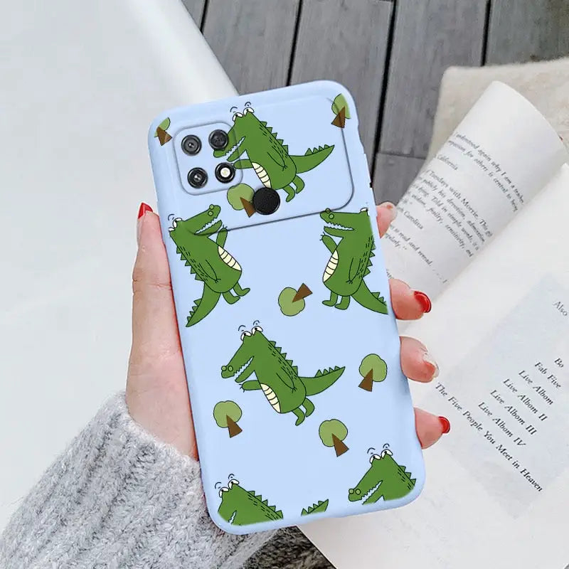 a woman holding a phone case with crocodiles on it