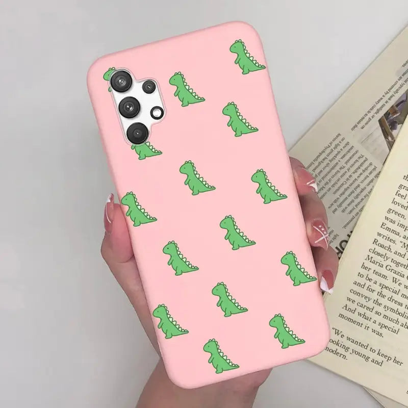 a woman holding a pink phone case with green alligators on it