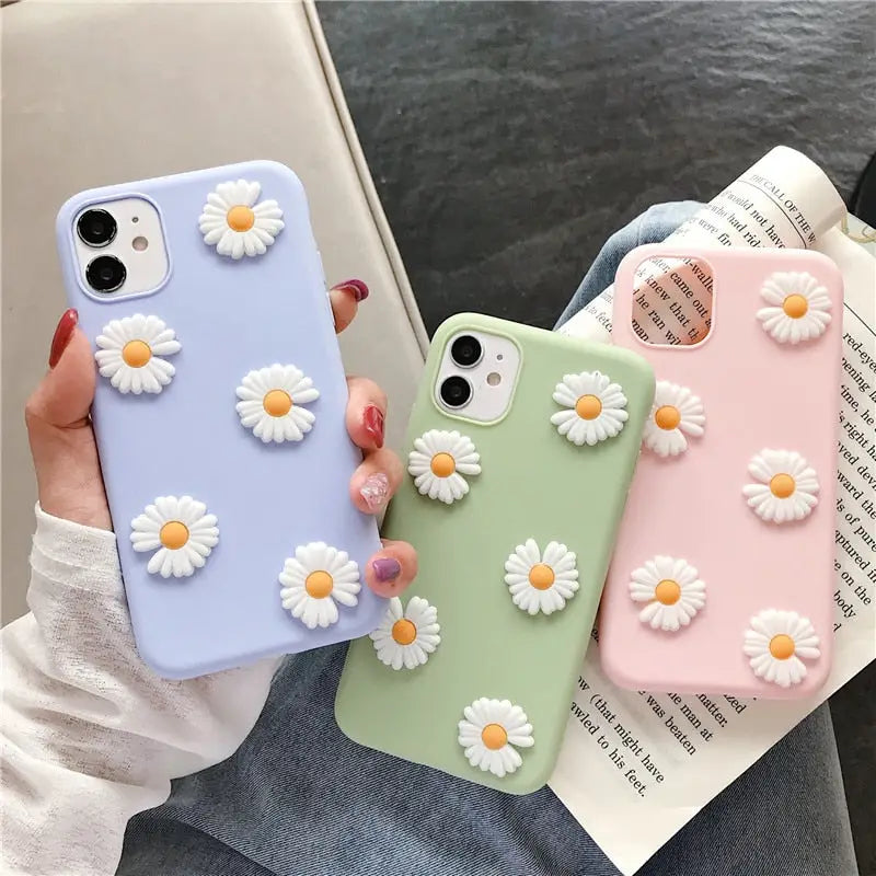 a close up of a person holding a phone case with flowers on it