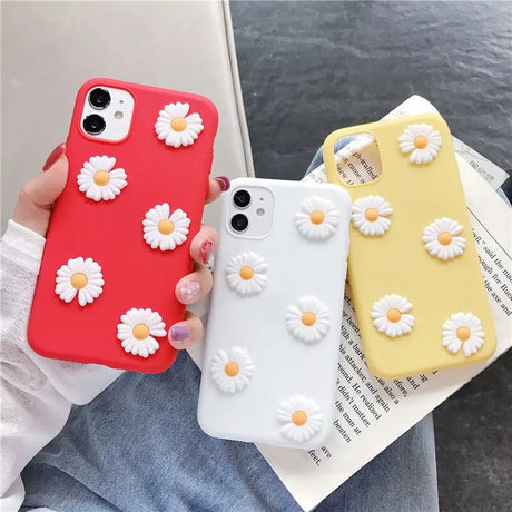 a woman holding a phone case with flowers on it