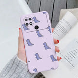 a woman holding a pink phone case with a pattern of dinosaurs on it