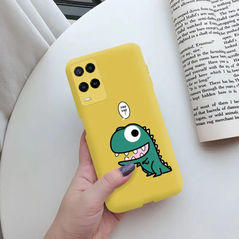 a person holding a yellow phone case with a cartoon character on it