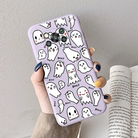 a woman holding a phone case with ghost pattern