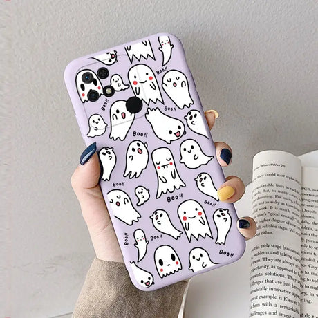 a woman holding a phone case with ghost pattern