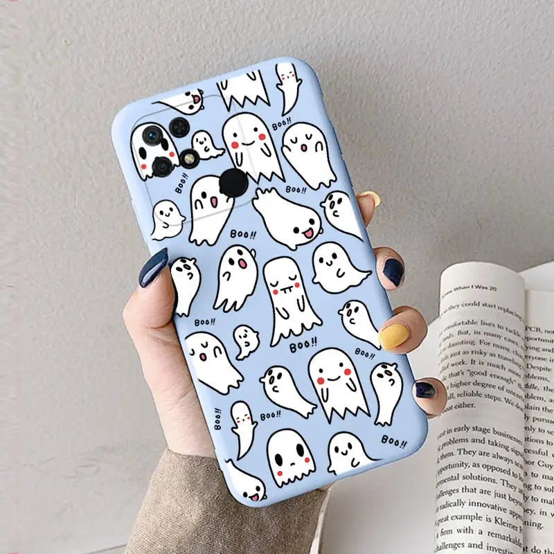 a woman holding a phone case with ghost pattern