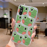 a person holding a phone case with a pattern of green and red fish