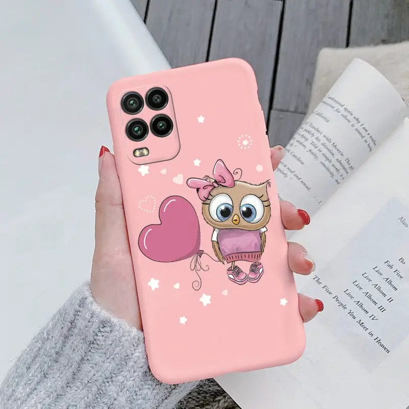 a girl holding a pink phone case with a cute owl on it