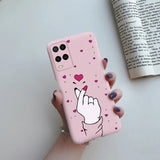 a pink phone case with a heart and a hand gesture