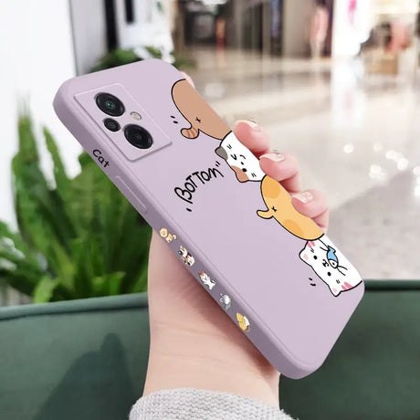 a woman holding a phone case with a cartoon cat on it