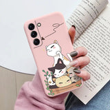 a woman holding a phone case with a cat on it