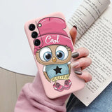 a girl with a pink hat and a pink owl phone case