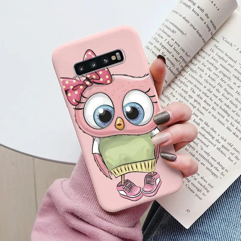 a girl holding a pink owl phone case