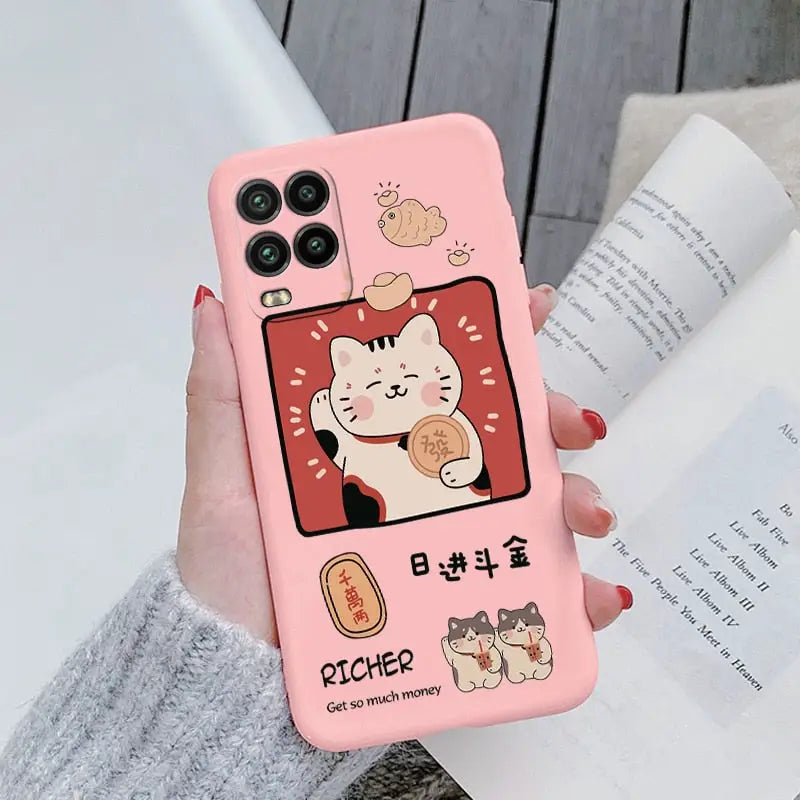 a woman holding a pink phone case with a cat and cat