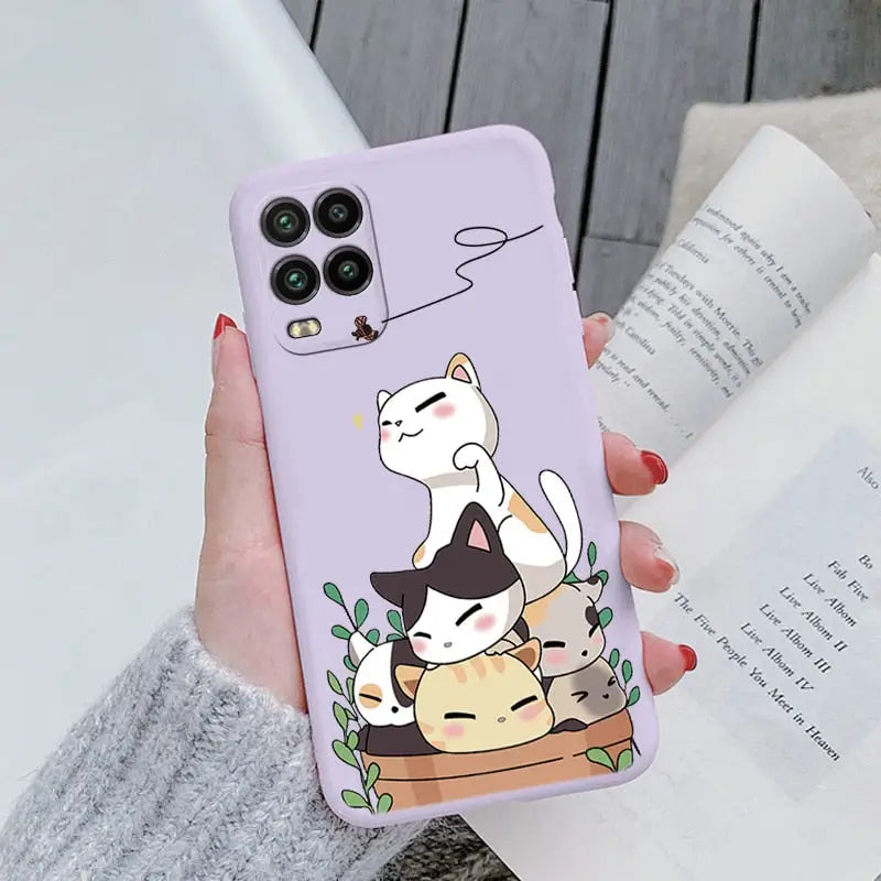 a woman holding a phone case with a cat on it