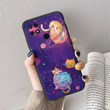 a woman holding a phone case with a cat and planets