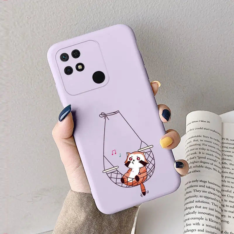 a woman holding a phone case with a cartoon cat on it