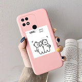a woman holding a pink phone case with a cat on it