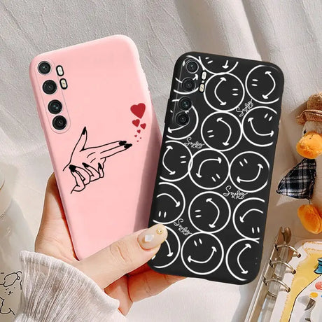 a woman holding a phone case with a heart on it