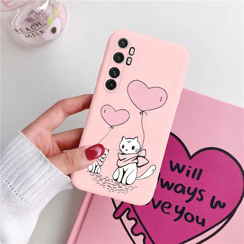 a pink phone case with a cartoon cat and heart