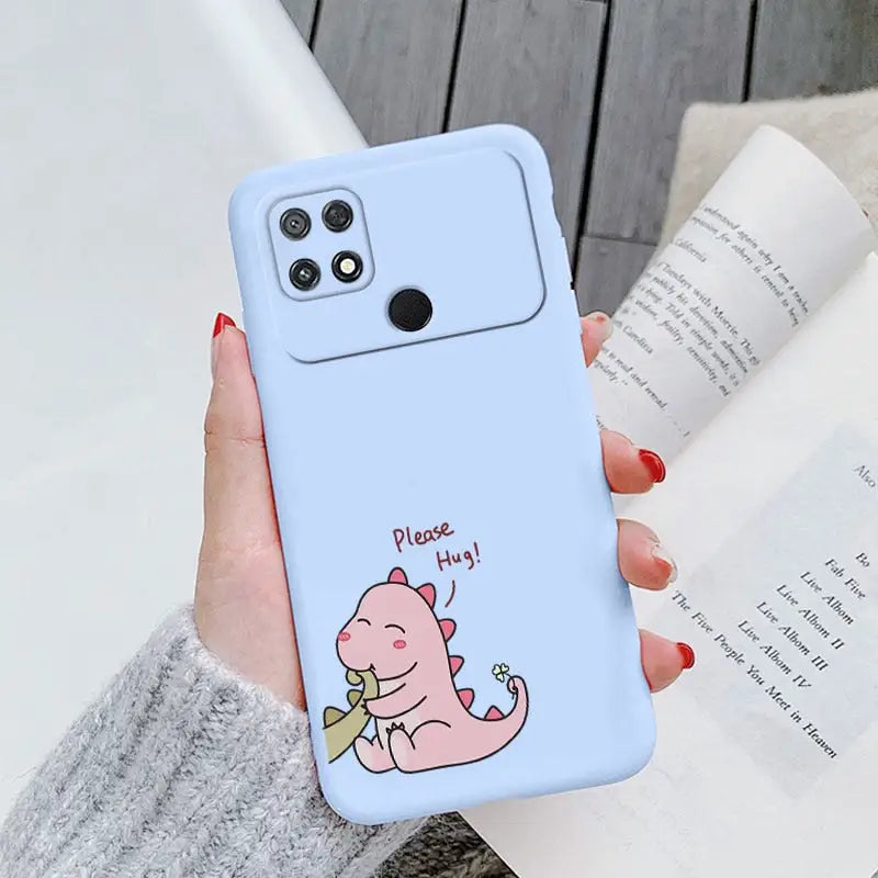 a woman holding a phone case with a pig on it
