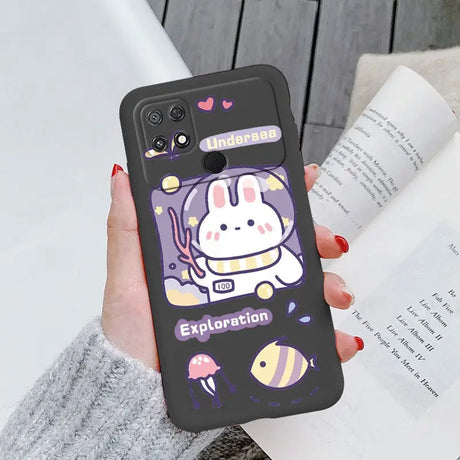 a woman holding a phone case with a cartoon character