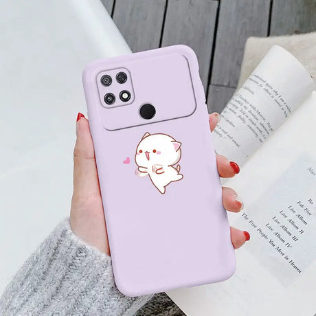 a woman holding a phone case with a cat on it