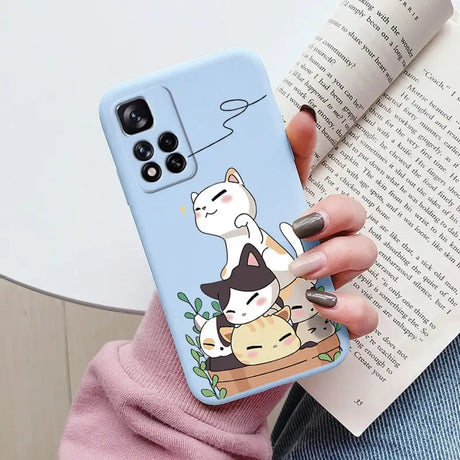 a woman holding a phone case with a cat and dog on it