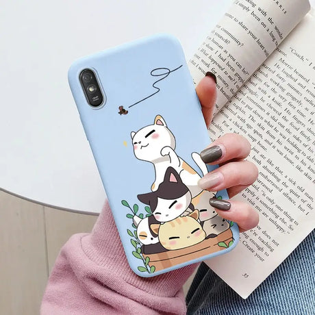 a woman holding a phone case with a cat and dog