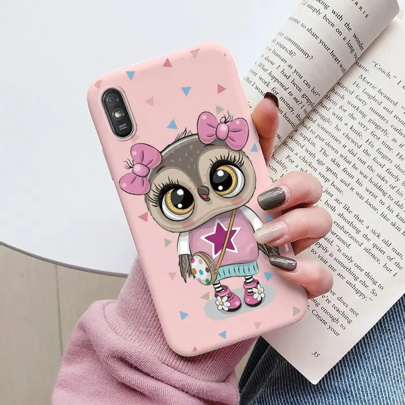 a girl with a pink heart and a pink bow on her head, holding a pink phone case