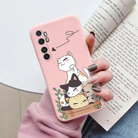 a woman holding a phone case with a cat on it