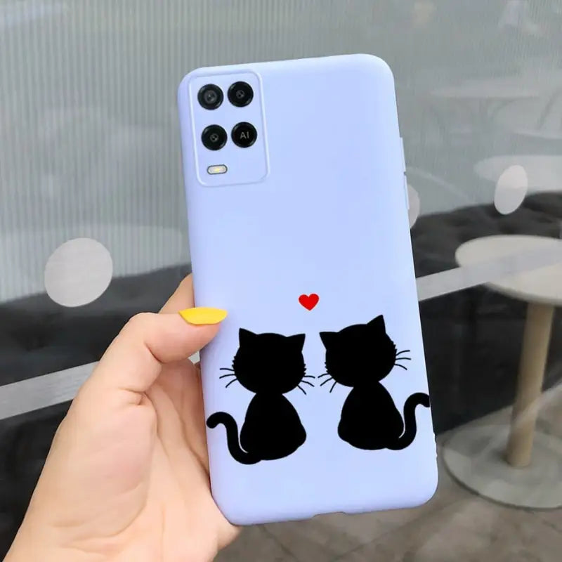 a person holding a phone case with a cat and heart