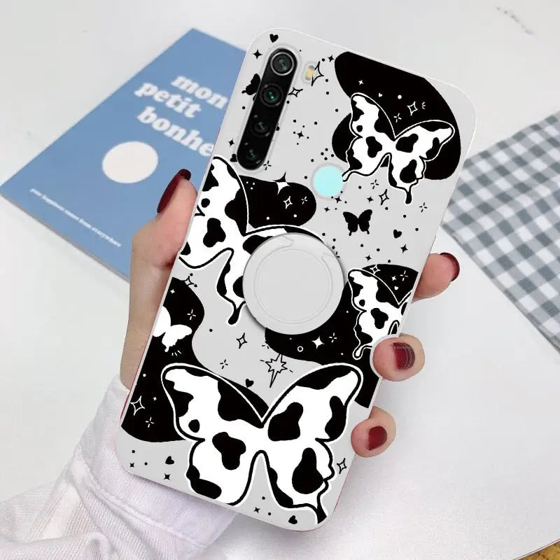 a woman holding a phone case with a cow pattern