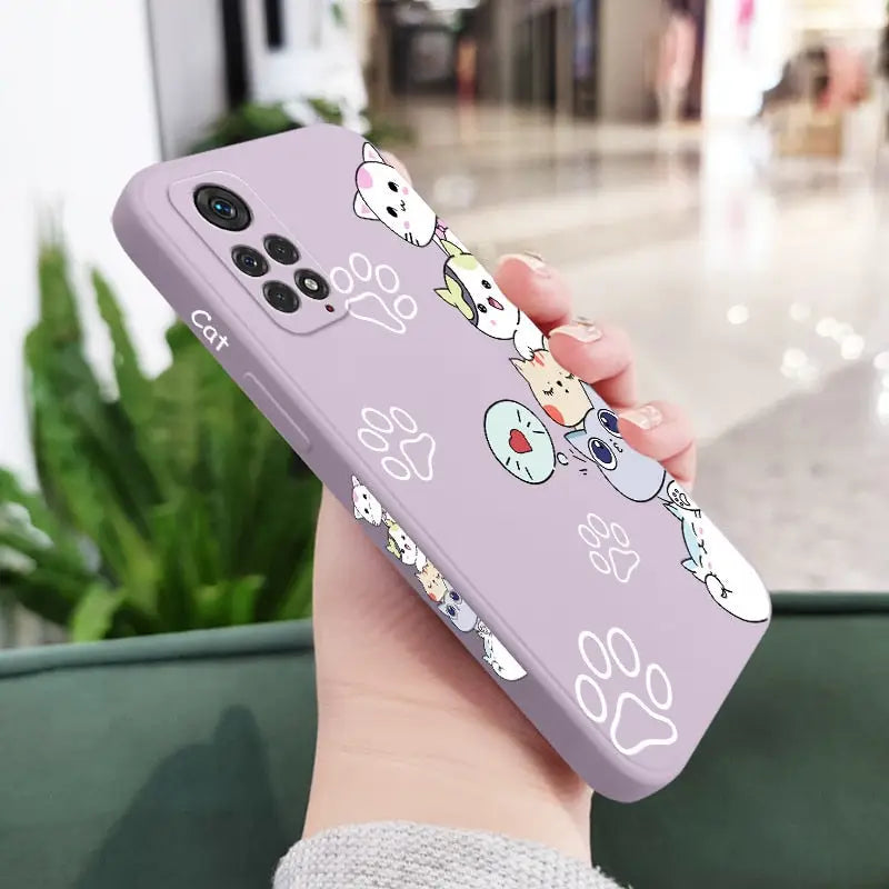 a woman holding a purple phone case with cartoon characters on it