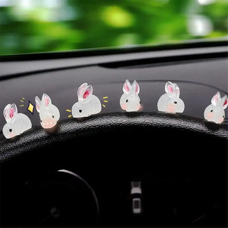 a car dashboard with a bunch of white rabbits on the dashboard